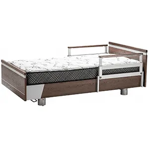 A hospital-style single bed, Apr2025 ImpulseEssence36, with a sturdy wooden frame, adjustable metal side rails, and a patterned mattress.