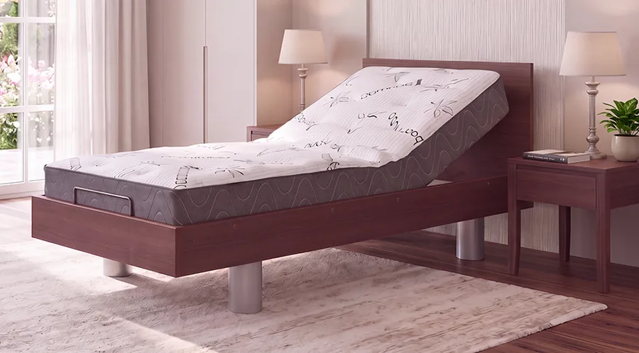 Adjustable Sondercare impulse bed with a raised head section in a modern bedroom, featuring wooden furniture, a lamp, and a window with natural light.