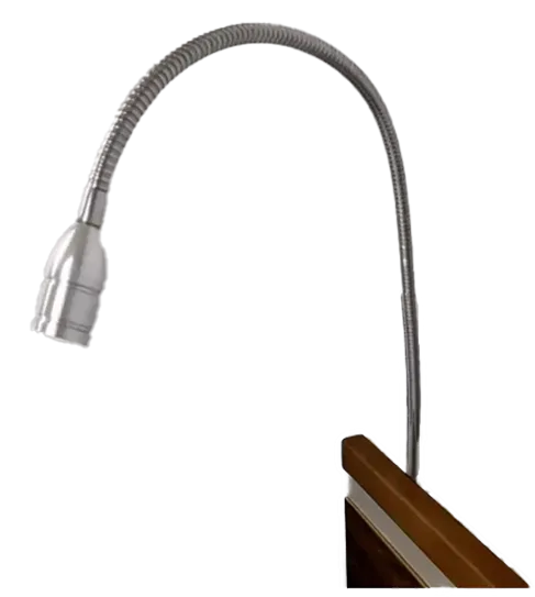 A flexible, metallic ImpulseEssence39 gooseneck lamp is attached to the edge of a wooden surface and extends upward and outward.
