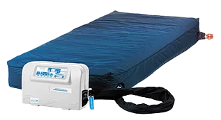 An inflatable hospital bed mattress with a blue cover, connected to a white air pump control unit.