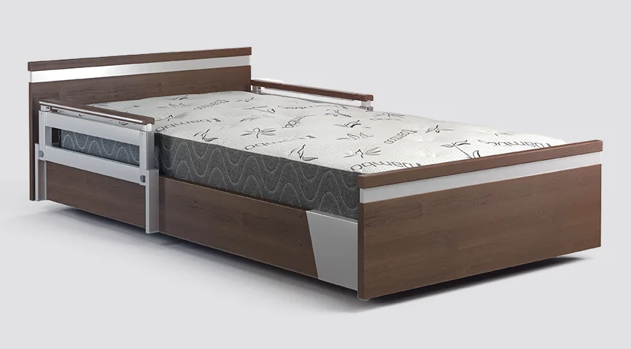 Wooden Seniors Bed with metal rails, featuring a white and gray patterned mattress.