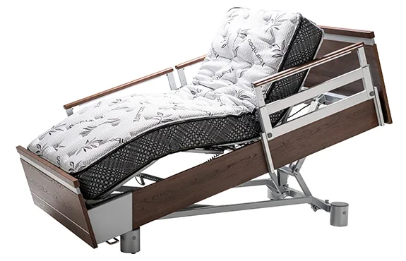 Adjustable hospital bed with a metal frame, wood panel accents, and a patterned mattress, shown in a raised head and knee position.