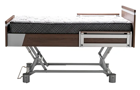 Adjustable hospital bed with a metal frame, dark wood accents, and a patterned mattress, shown in a side profile view.